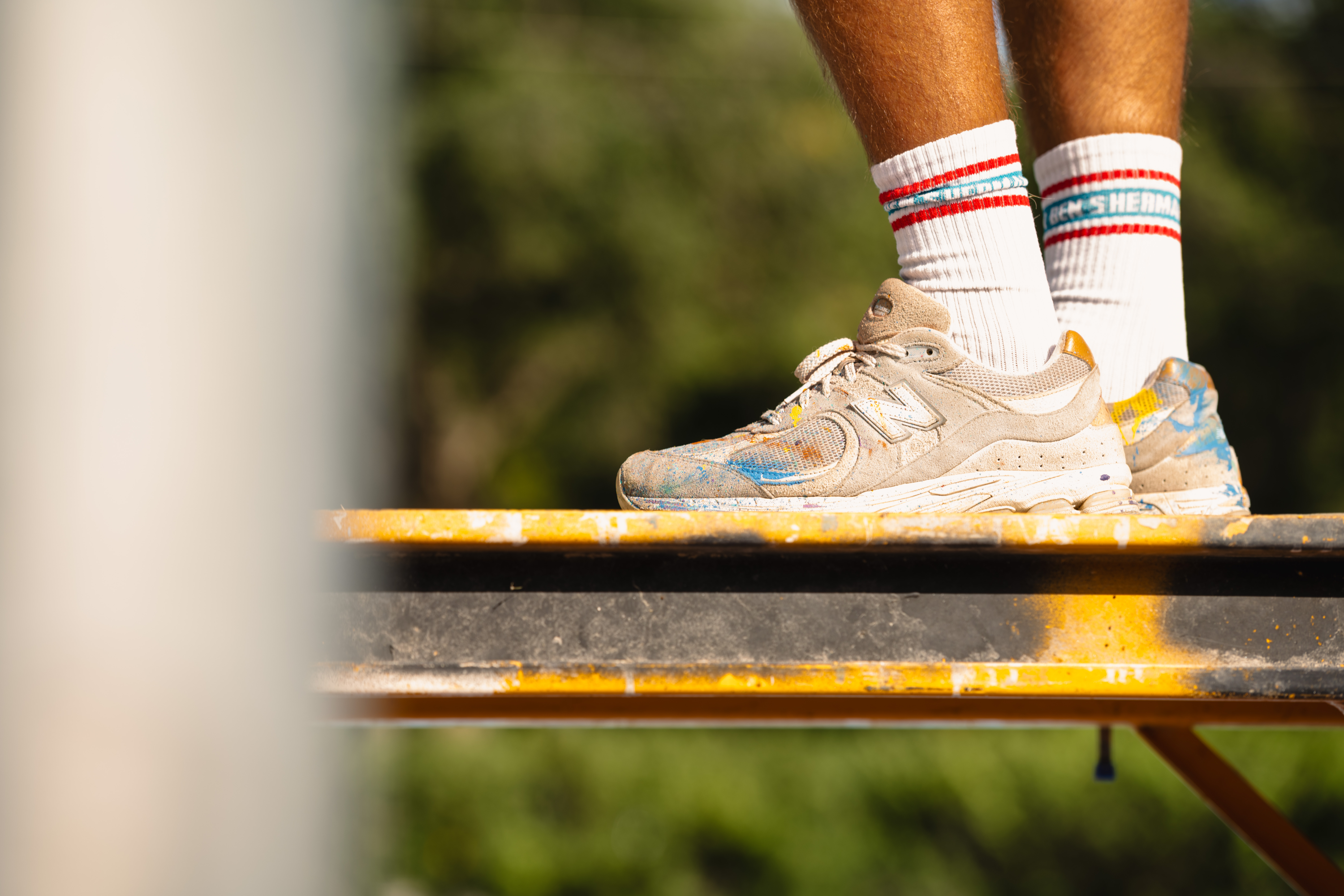 Paint-splattered shoes on a ladder
