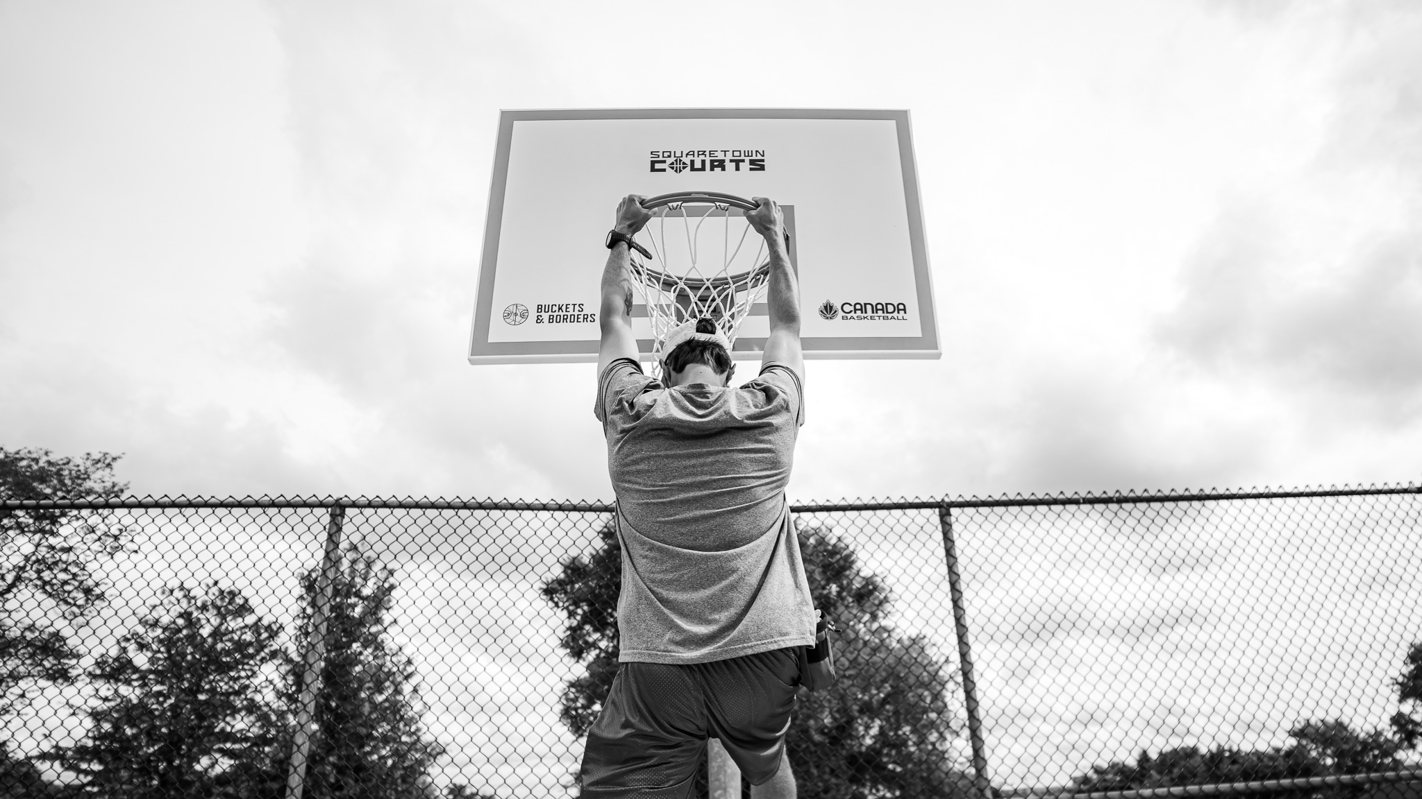Hanging from a basketball hoop