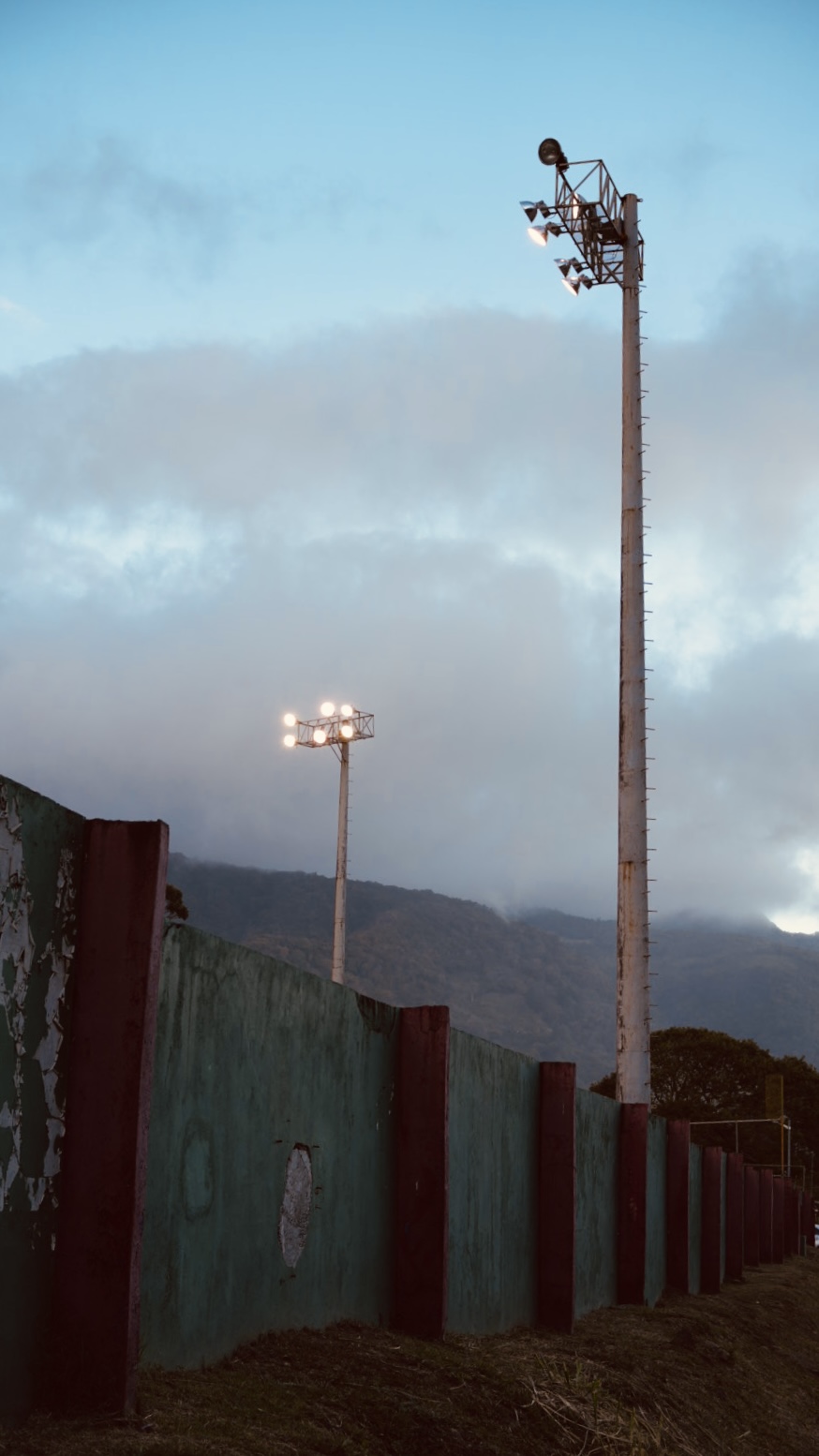 Stadium floodlights against a moody sky